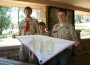 Members of Osawatomie Boy Scout troop 3099 Jerrod Bechtel, Brandon Guilfoyle, and Tanner Schwalm hold up a 100 Anniversary of Boy Scouts neckerchief.  The boys returned recently from having attended the jamboree at Camp A.P. Hill in Virginia.