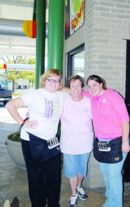 Osawatomie's Sonic Drive-In had some special car hops Saturday. Volunteers work two hour shifts to raise money for breast cancer research. Joan Vandebergh (center) coordinated the event. Pictured with her are two of the volunteers, Jennifer Bratton (left) and Savannah White. The volunteer raised $473.