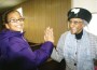 Alexis Hinton, great granddaughter of the Rev. Willie Hinton of Osawatomie, shares a high-five with Ruth Wrench, who was celebrating 102nd birthday on Dec. 23